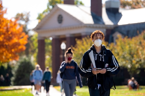 Students wearing masks walk across Malesardi Quad in fall 2020