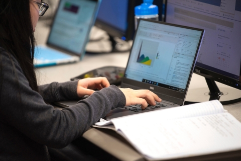 A student works on a graph on a laptop