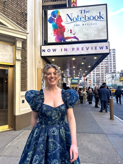 Goldie stands in front of The Notebook, Broadway marquee in New York City