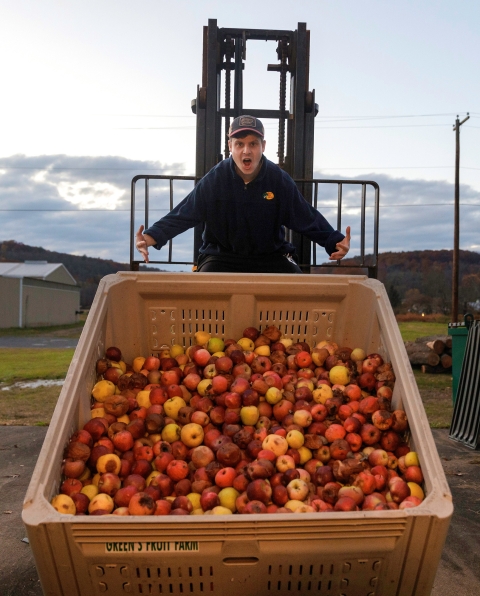 Ben Fink with a large container of apples.