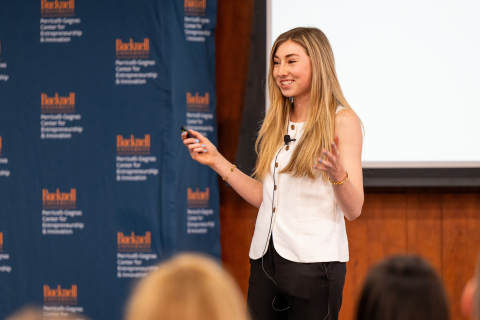 Anna Ottman smiles while addressing an audience.