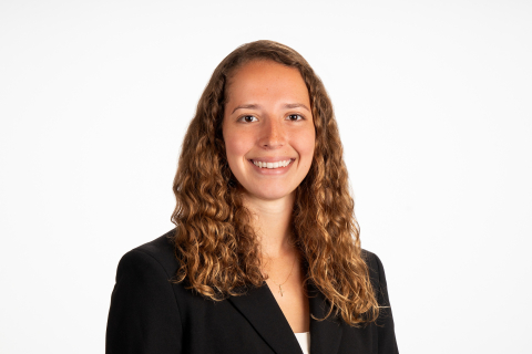 Brylee Tereska smiles wearing a dark blazer against white background.
