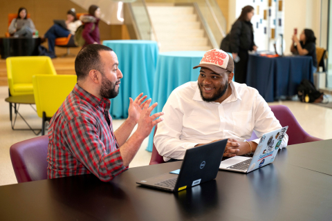 Tony Gomez and Kenneth Scott Jr. sit in Holmes Hall and talk