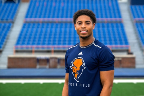 Chris Sims poses for a portrait in front of the stands at Christy Mathewson-Memorial Stadium