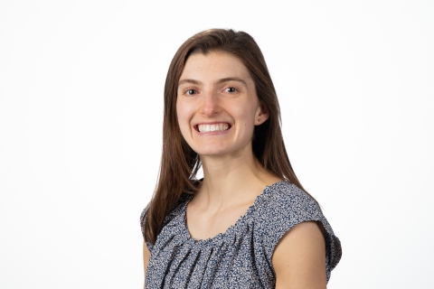 Meghan Catherwood smiles wearing a gray top against a white background.