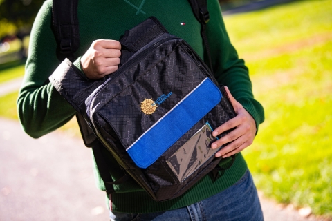 Shehryar holds the solar backpack.