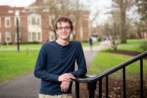 Michael Bolish leans on a railing on the staircase outside Dana Engineering Building