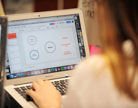 Student creates a powerpoint on her laptop
