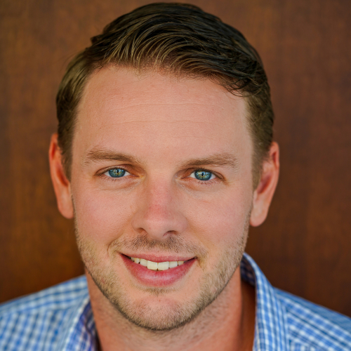 A portrait of a young man in blue plaid shirt.